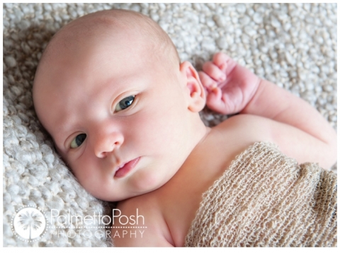 newborn baby boy looking at camera